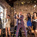 Competition winners in a studio celebrating with confetti and champagne