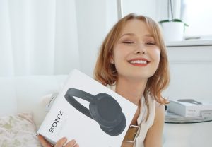 A picture of Beth with our sony headphones prize