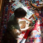 A boy, playing with Lego on his bedroom floor