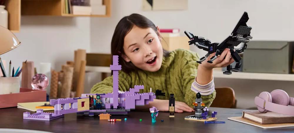 Girl playing with the ender dragon and end ship Minecraft lego set