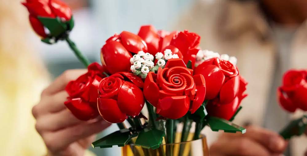 Hands arranging the lego bouquet of roses