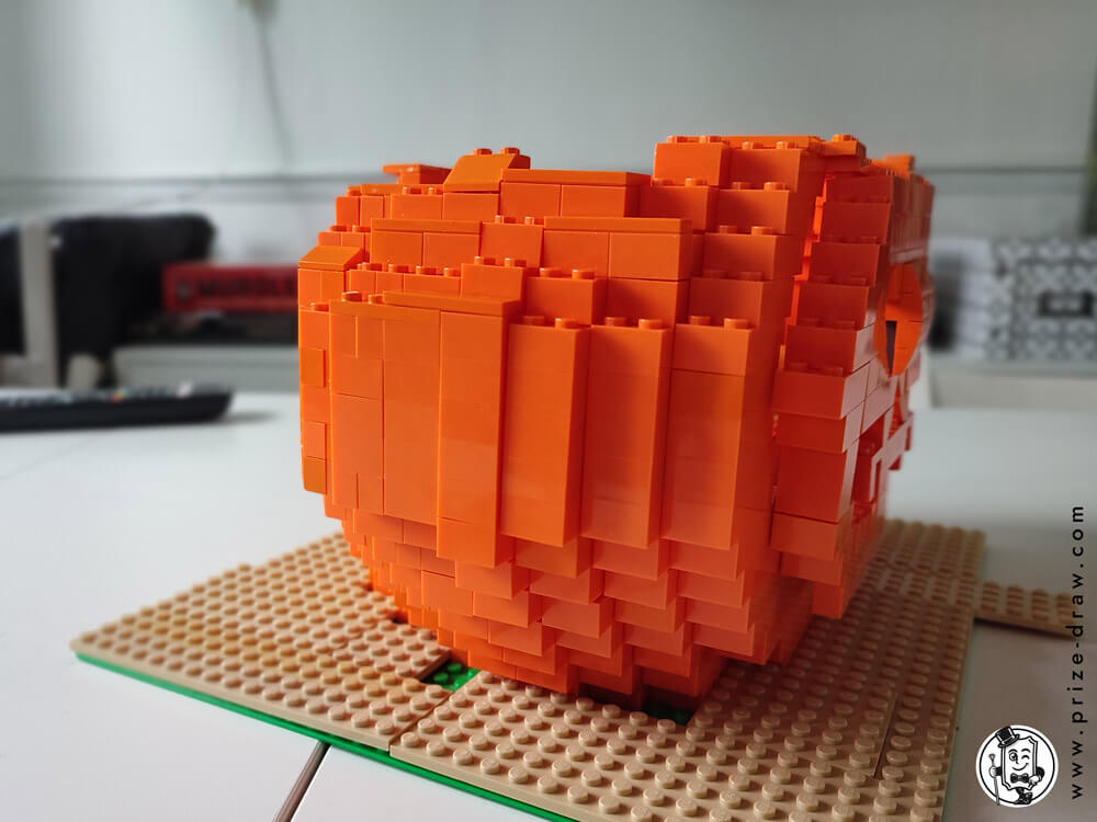 Close up side view of pumpkin lego head