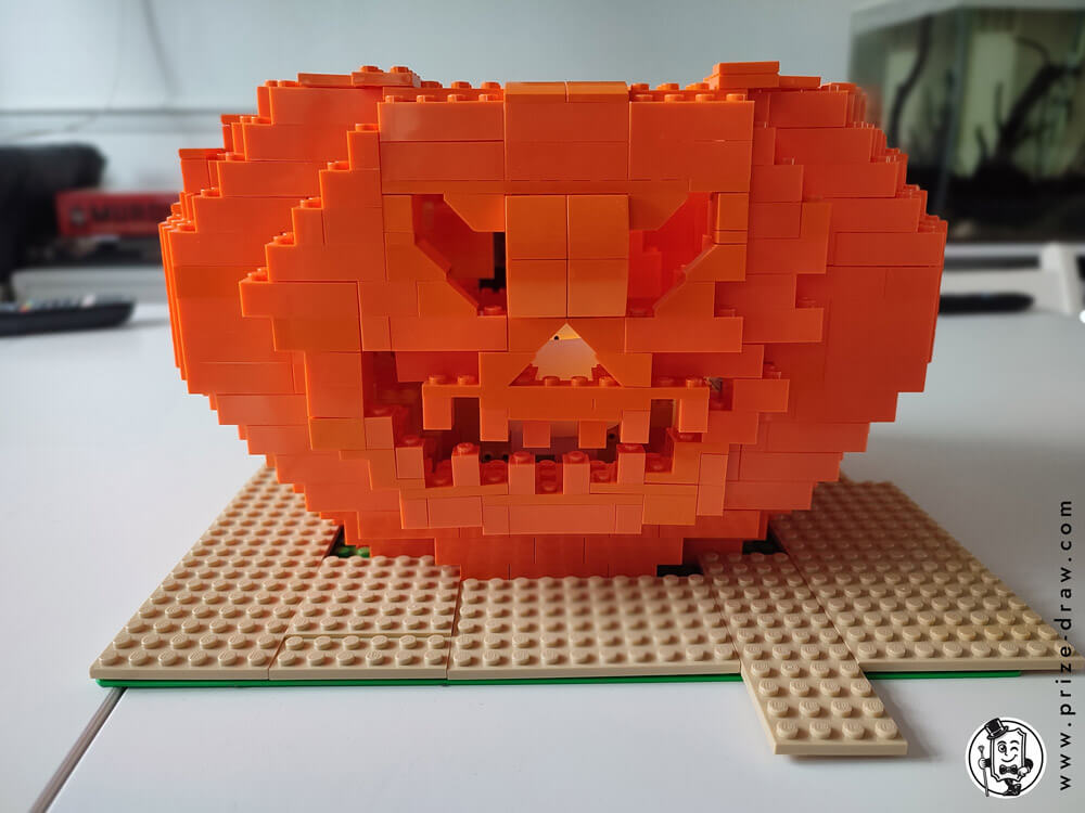 Front on view of the lego pumpkin head with the candle showing inside