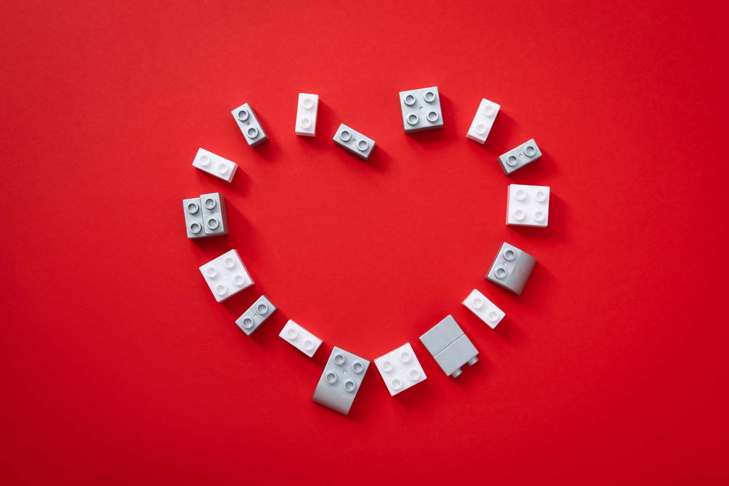 Love heart on a red background, made out of lego